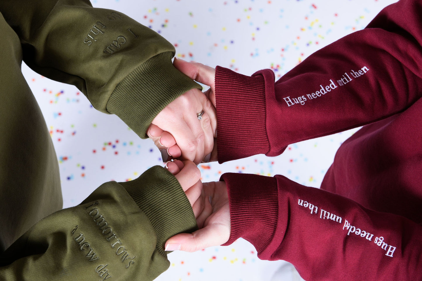 Our Surviving khaki green embroidered jumper from our mental health clothing collection, featuring the uplifting message "Tomorrow's a new day" and "I can do this" elegantly stitched on the sleeves to inspire resilience.