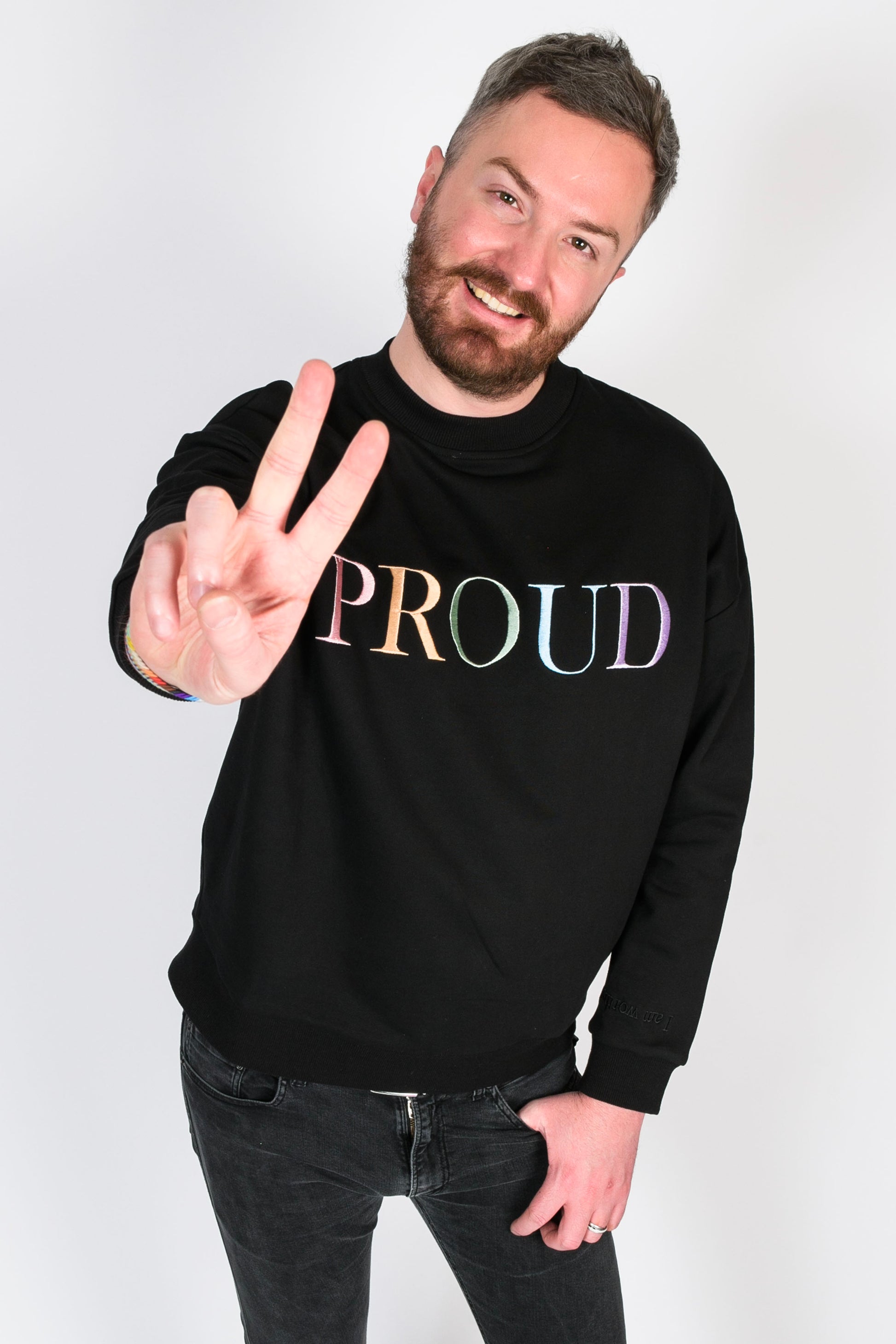 A beautiful black high quality oversized Jumper with a pastel rainbow letters spelling out 'PROUD.' The sleeves have reassuring messages which read 'I am Loved' and 'I am Worthy'