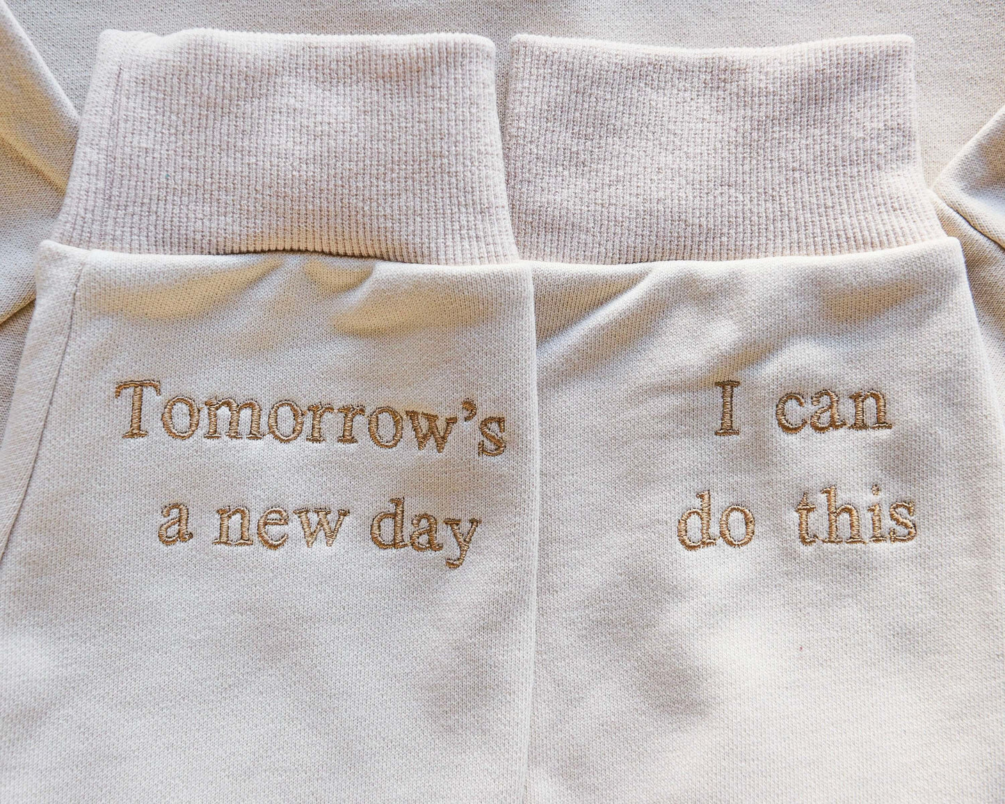 A picture of the cuffs of the sleeves which reads 'I can do this' and 'Tomorrow's a new day '