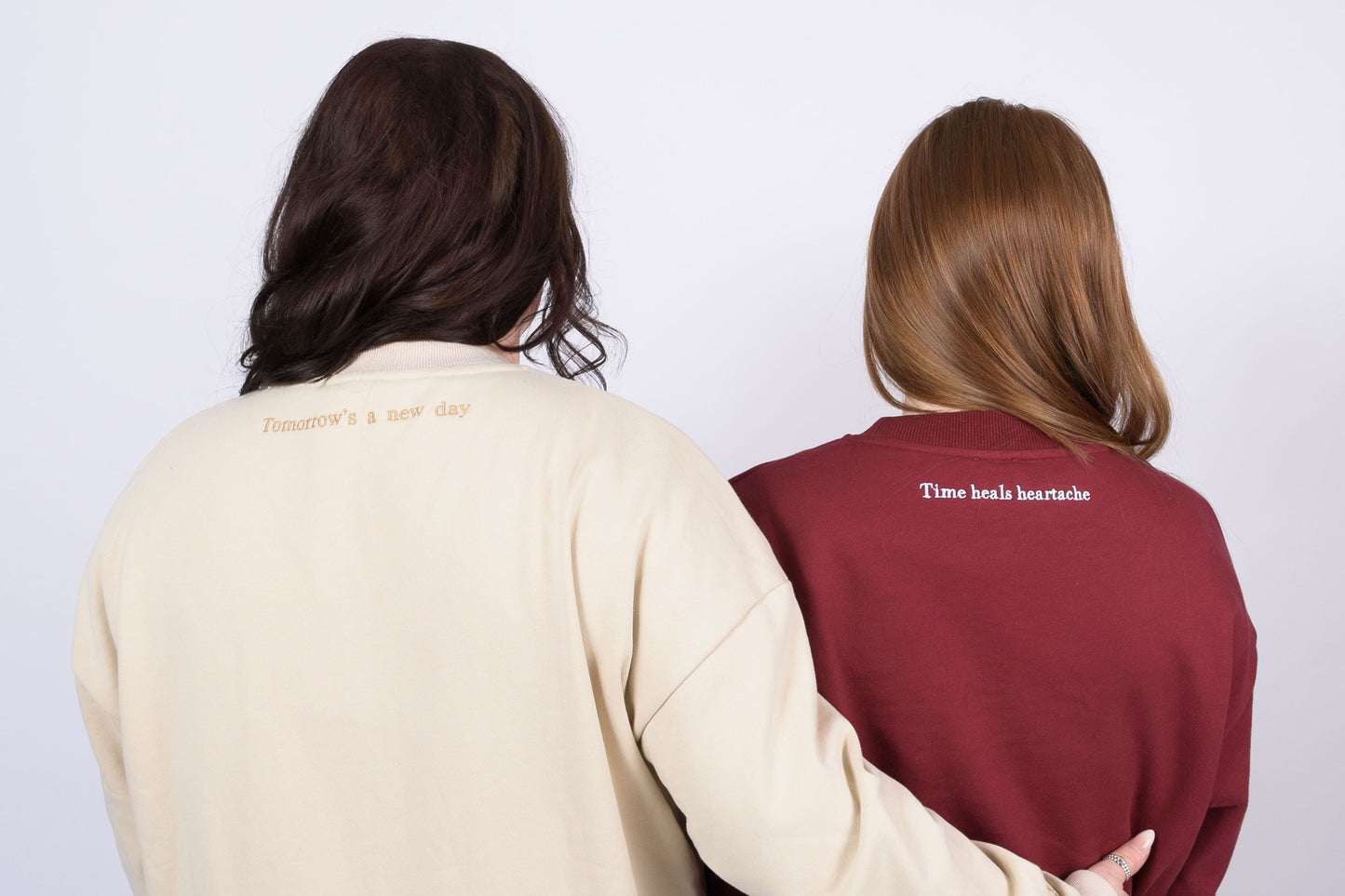 Our Surviving beige embroidered jumper from our mental health clothing collection, featuring "Tomorrow's a new day" elegantly stitched on the back of the jumper to inspire resilience.