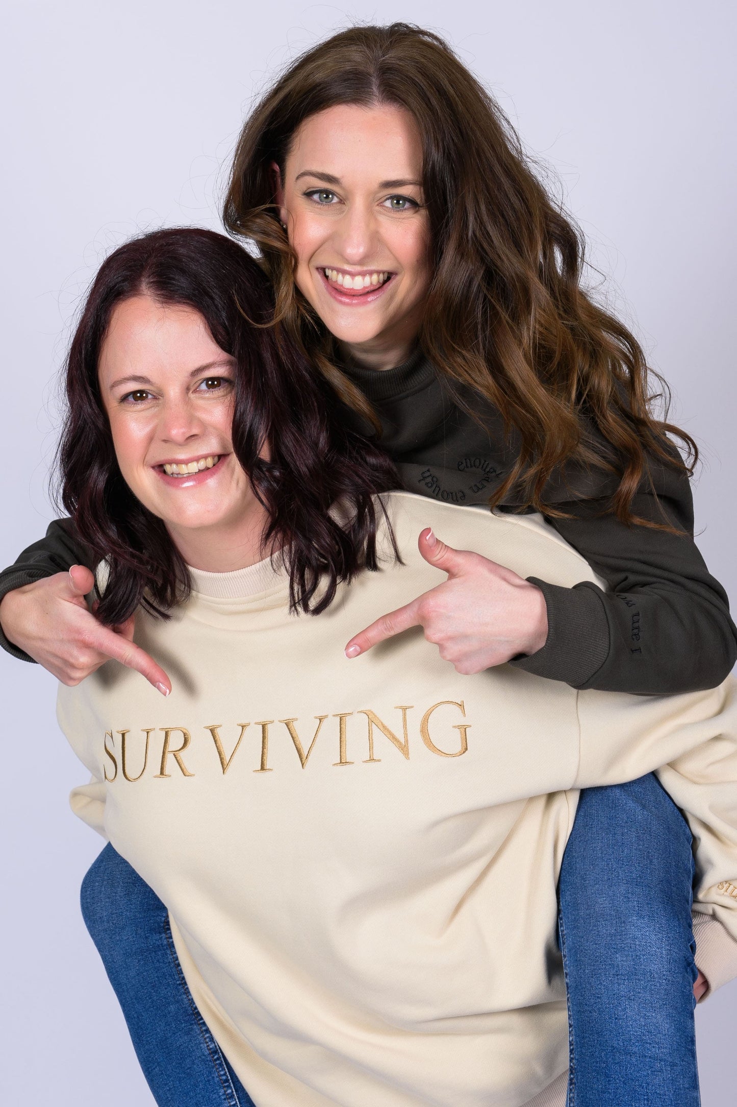 Our Surviving beige embroidered jumper from our mental health clothing collection, featuring the uplifting message "Surviving" across the chest and phrases include "Tomorrow's a new day" elegantly stitched to inspire resilience.